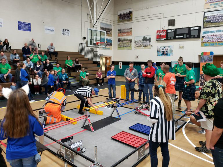 Opposing team members competing in the First Tech Challenge.